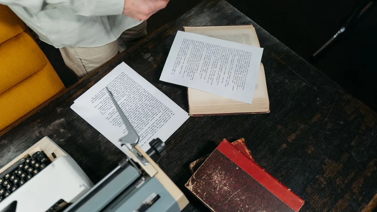 A desk covered with printed research papers
