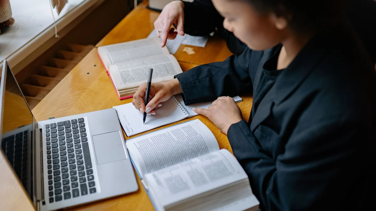 A student working through books and notes