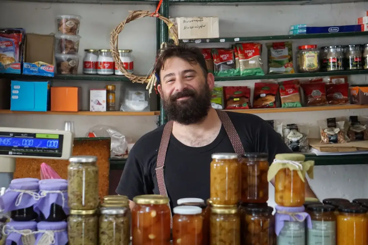 Small business owner standing behind the counter of his shop